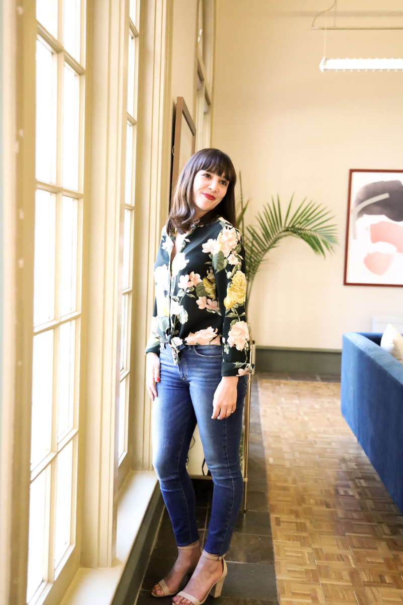 Caroline Maurer, Founder of Figment Cottage Gardens in a floral blouse in front of a window